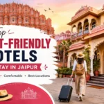 Best budget-friendly hotels in Jaipur featuring a heritage hotel, Hawa Mahal, and a traveler with luggage in Rajasthan